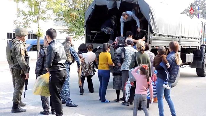 Russian peacekeepers evacuate civilians in the town of Askeran following the launch of a military operation by Azerbaijani forces in the region of Nagorno-Karabakh, a region inhabited by ethnic Armenians, in this still image from video published September 20, 2023 | Russian defence ministry/handout via Reuters