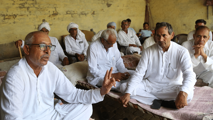 Wrestler Vishal's father Subhash Kaliraman (extreme left) with fellow villagers of Sisai in Hisar | Suraj Singh Bisht | ThePrint