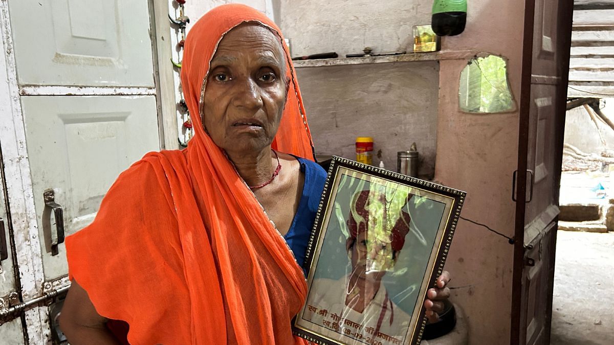 Bhanwari holding a photo of her husband Mohan Lal Prajapat. He died in 2020 due to cancer.  | Jyoti Yadav | ThePrint