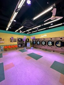 A set resembling a Laundromat on the floor housing the K-pop Ground | Photo: Monami Gogoi | ThePrint
