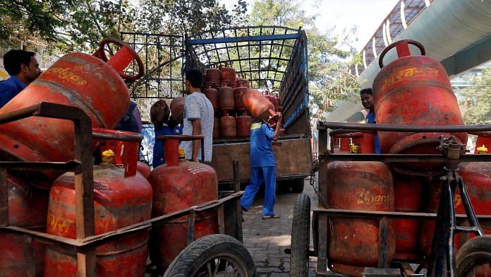 Workers load liquefied petroleum gas (LPG) cooking cylinders onto a supply truck outside a distribution centre in Mumbai, India | Reuters file photo