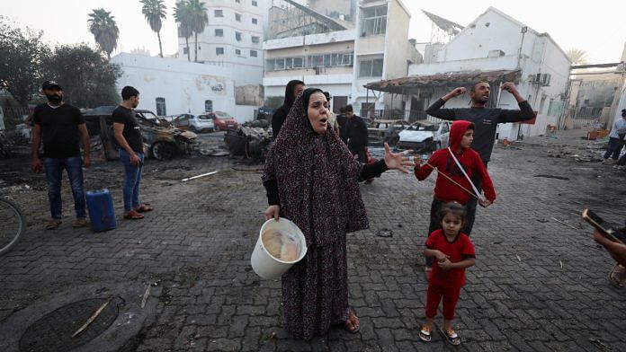 People react at the area of Al-Ahli hospital, where hundreds of Palestinians were killed in a blast that Israeli and Palestinian officials blamed on each other, in Gaza City, October 18, 2023 | Reuters