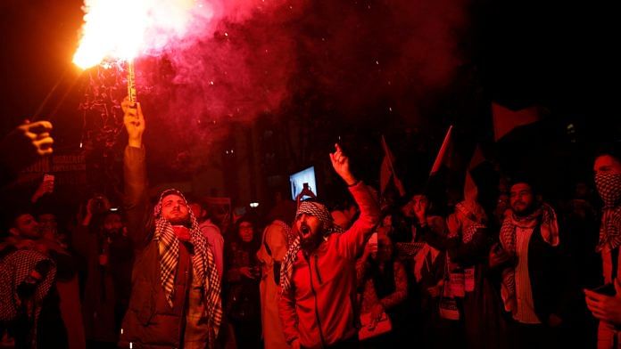 Pro-Palestinian demonstrators light flares during a protest near the Israeli Consulate as the conflict between Israel and Hamas continues, in Istanbul, Turkey | Reuters