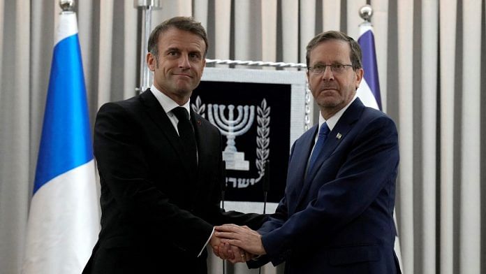 French President Emmanuel Macron, left, shakes hands with Israel's President Isaac Herzog in Jerusalem, on 24 October 2024 | Christophe Ena/Pool via Reuters