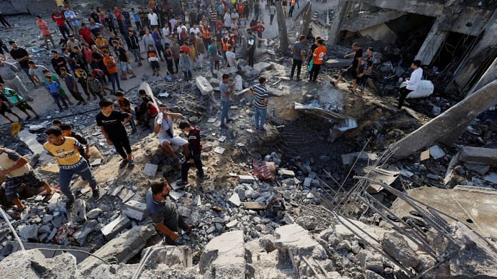 Palestinians search for casualties under rubble of a building destroyed by Israeli strikes in Khan Younis in southern Gaza Strip on October 17, 2023 | Representational image | REUTERS/Mohammed Salem