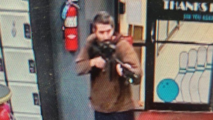 A man identified as a suspect by police points what appears to be a semiautomatic rifle, in Lewiston, Maine, US | Androscoggin County Sheriff’s Office via Facebook/Handout via Reuters