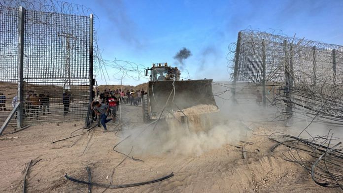 Palestinians break into Israeli side of Israel-Gaza border fence on 7 October, 2023 | Reuters/Mohammed Fayq Abu Mostafa