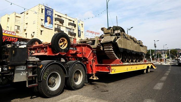 A tank is driven on a tank transporter on a road in Kiryat Shmona, northern Israel | Reuters