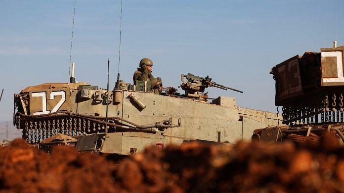 An Israeli soldier is seen in a tank during a military drill near Israel's border with Lebanon in northern Israel | Reuters
