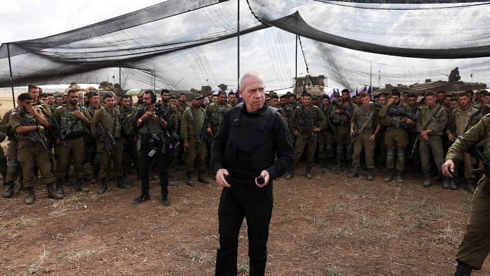 Israel's Defence Minister Yoav Gallant meets soldiers in a field near Israel's border with the Gaza Strip, in southern Israel October 19, 2023 | Reuters/Ronen Zvulun