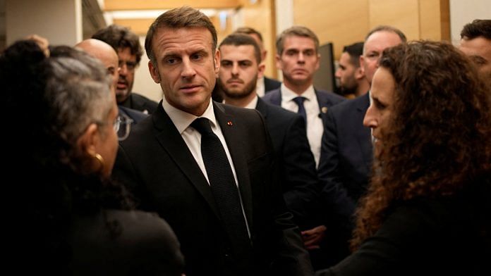 French President Emmanuel Macron meets with Israeli-French nationals who have lost loved ones, as well as families of hostages, at the Ben Gurion airport in Tel Aviv, on 24 October | Christophe Ena/Pool via Reuters