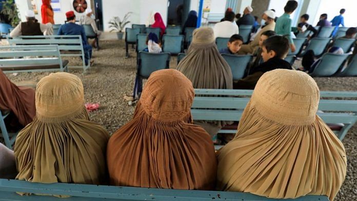 Afghan women who are living in Pakistan wait to get registered during a proof of registration drive at the UNHCR office in Peshawar | Reuters file photo