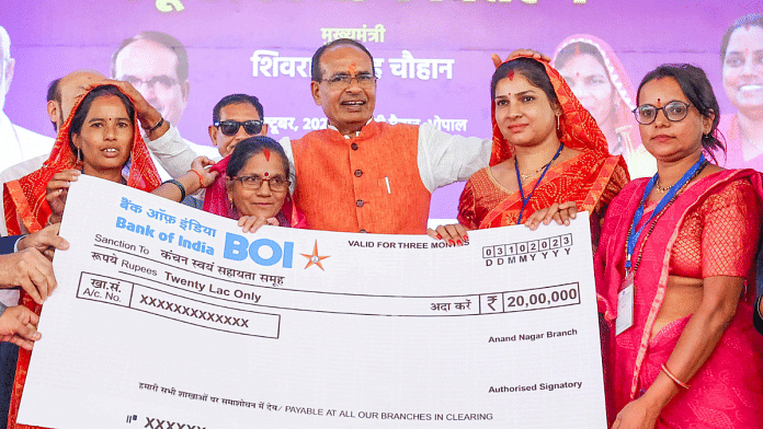 Madhya Pradesh CM Shivraj Singh Chouhan distributes a cheque of Rs 20 lakh to the women beneficiaries during the women self-help group conference at Jamboree Ground in Bhopal on 4 October | ANI