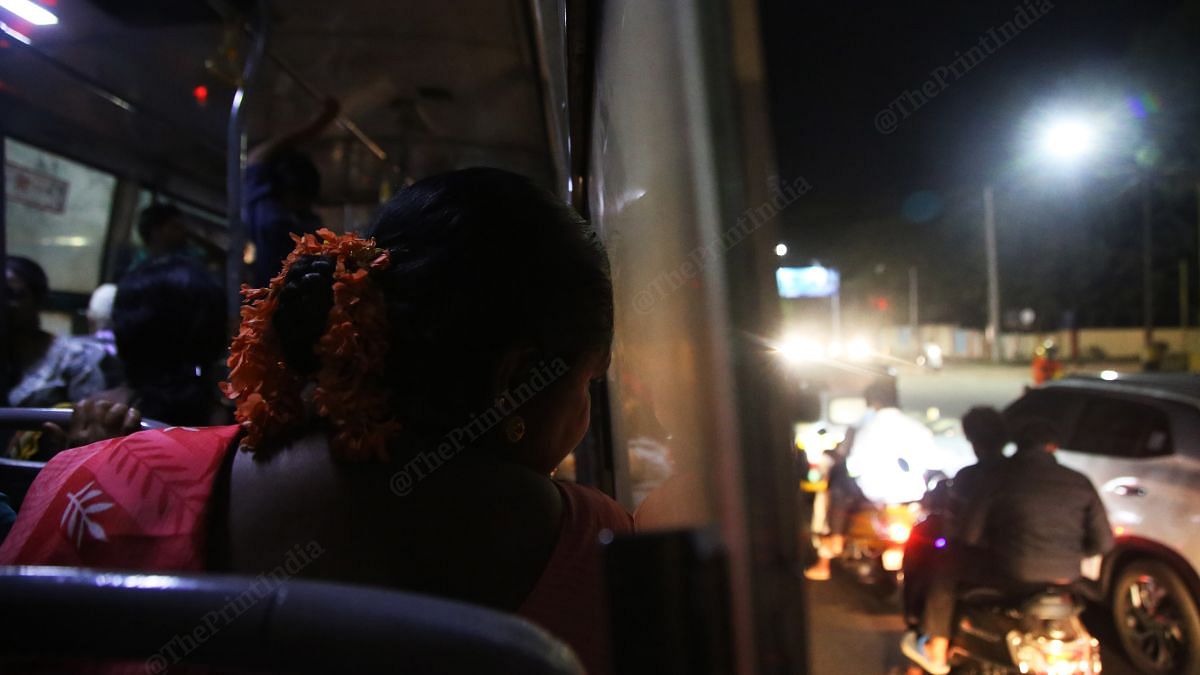 A woman looks outside the bus window while leaving the Mysuru city centre | Manisha Mondal, ThePrint