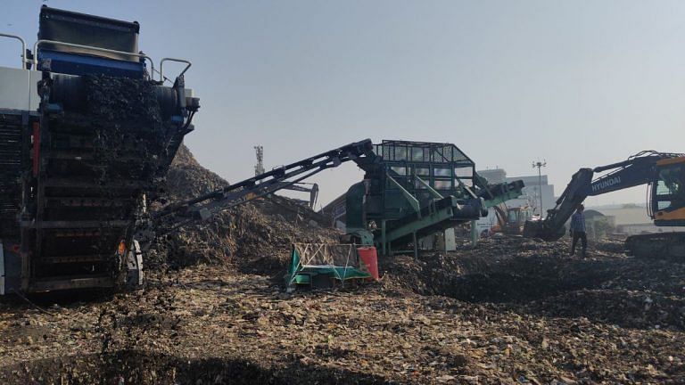 Machines are digging, dragging, tearing into Delhi garbage mountains. Time’s running out