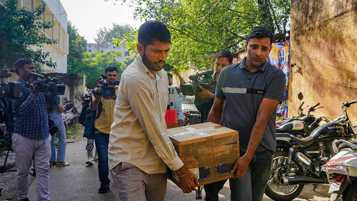 File photo of Delhi Police personnel with boxes of material confiscated from office of NewsClick | PTI