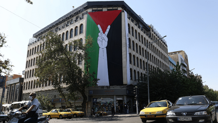 A huge Palestinian flag is seen on a building in a street in Tehran, Iran | Majid Asgaripour/WANA (West Asia News Agency) via REUTERS.