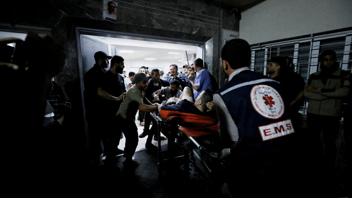 An injured person is assisted at Shifa Hospital after hundreds of Palestinians were killed in a blast at Al-Ahli hospital in Gaza | Reuters