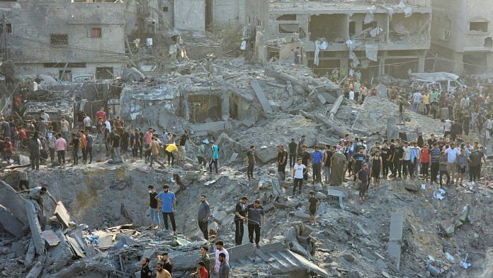 Palestinians search for casualties at the site of Israeli strikes on houses in Jabalia refugee camp in the northern Gaza Strip | Reuters