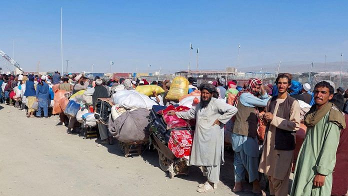 Afghan citizens wait with their belongings to cross into Afghanistan, after Pakistan gives the last warning to undocumented immigrants to leave, at the Friendship Gate of Chaman Border Crossing along the Pakistan-Afghanistan Border in Balochistan Province, in Chaman, Pakistan | Reuters