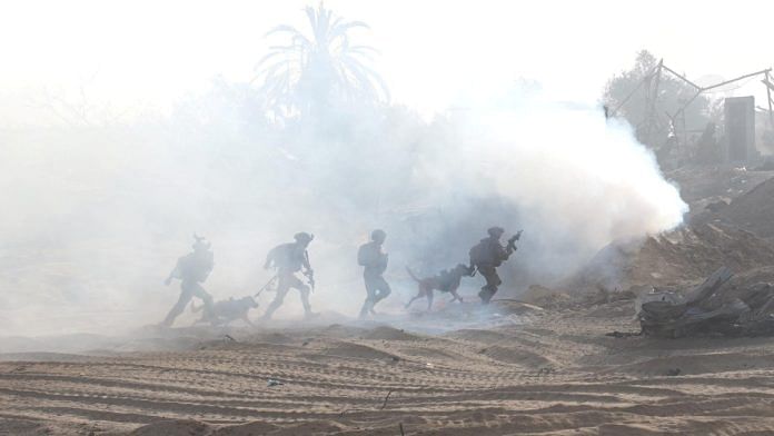 Israeli soldiers take a position inside the Gaza Strip, amid the ongoing ground operation of the Israeli army against Palestinian Islamist group Hamas, according to the Israeli Defense Forces (IDF), in this handout picture obtained by Reuters on November 11, 2023. Israeli Defense Forces/Handout via Reuters