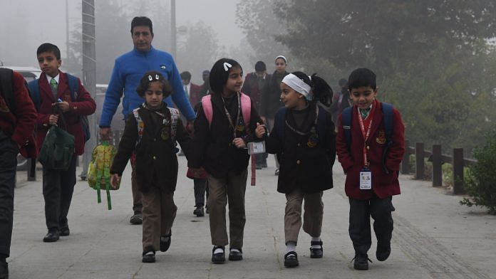 Children on their way to a school amid dense fog | ANI