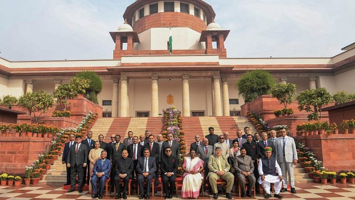 President Droupadi Murmu in a group photo with Chief Justice of India DY Chandrachud and others during Constitution Day celebrations organised by the Supreme Court of India, in New Delhi on Sunday -- PTI Photo