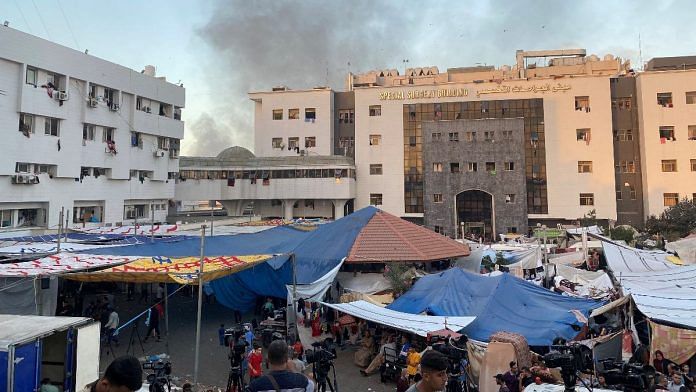 Smoke rises as displaced Palestinians take shelter at Al Shifa hospital in Gaza | Reuters