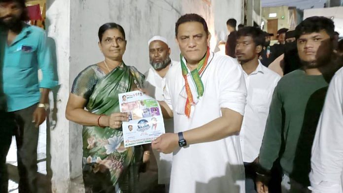 Mohammed Azharuddin hands a leaflet to a local resident while campaigning in Borabanda | Photo: Prasad Nichenametla | ThePrint
