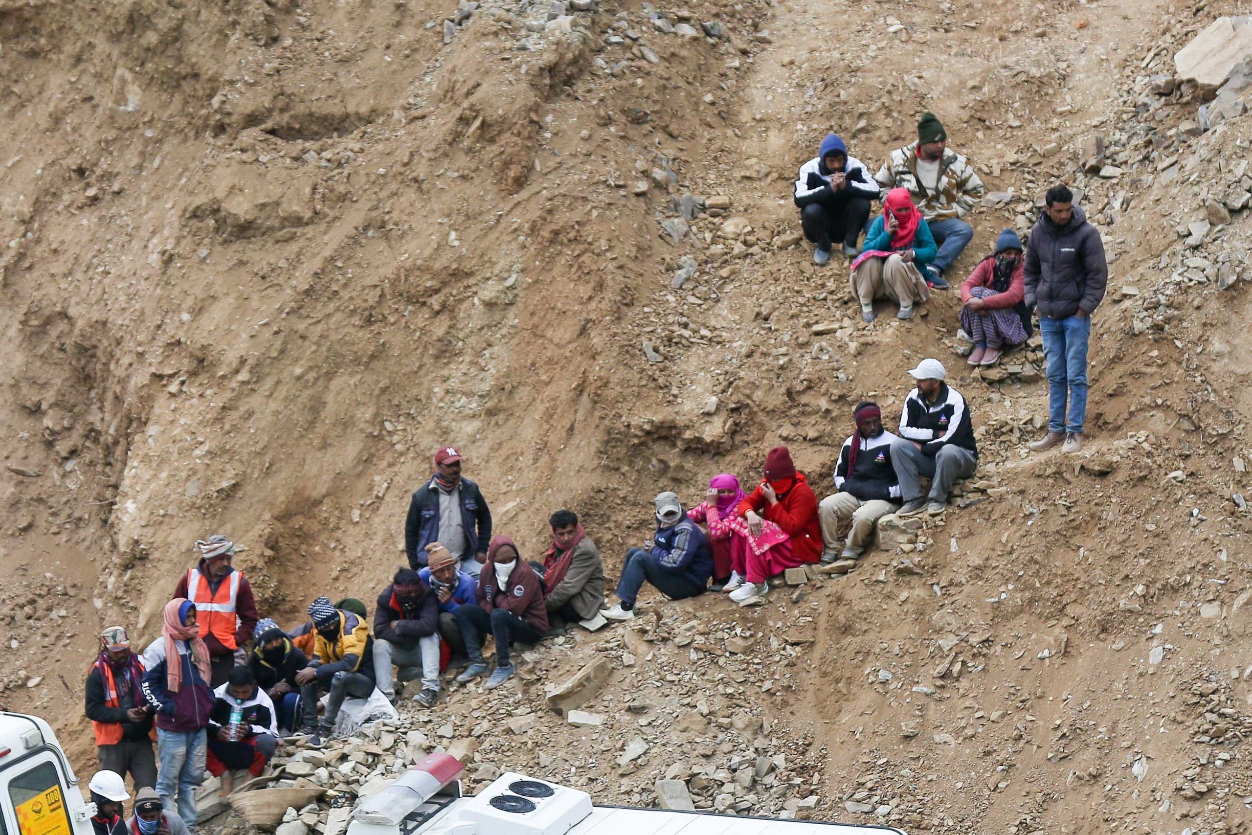 workers gather to look at the efforts by the operatives to rescue the 41 men trapped inside the collapsed under construction Silkyara tunnel in the Uttarkashi district of India's Uttarakhand state | Suraj Singh Bisht | ThePrint