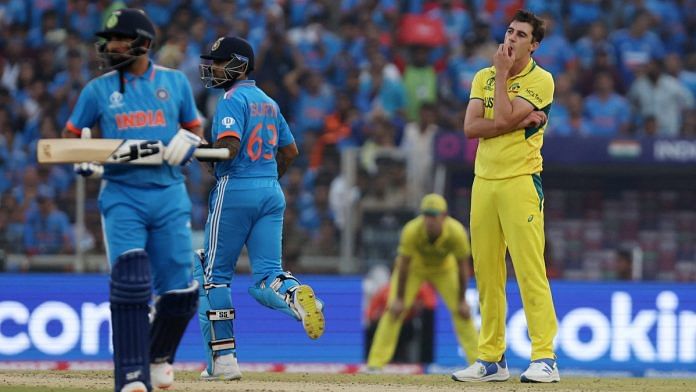 Australia's Pat Cummins reacts as India's Suryakumar Yadav and Mohammed Shami run between the wickets | Reuters