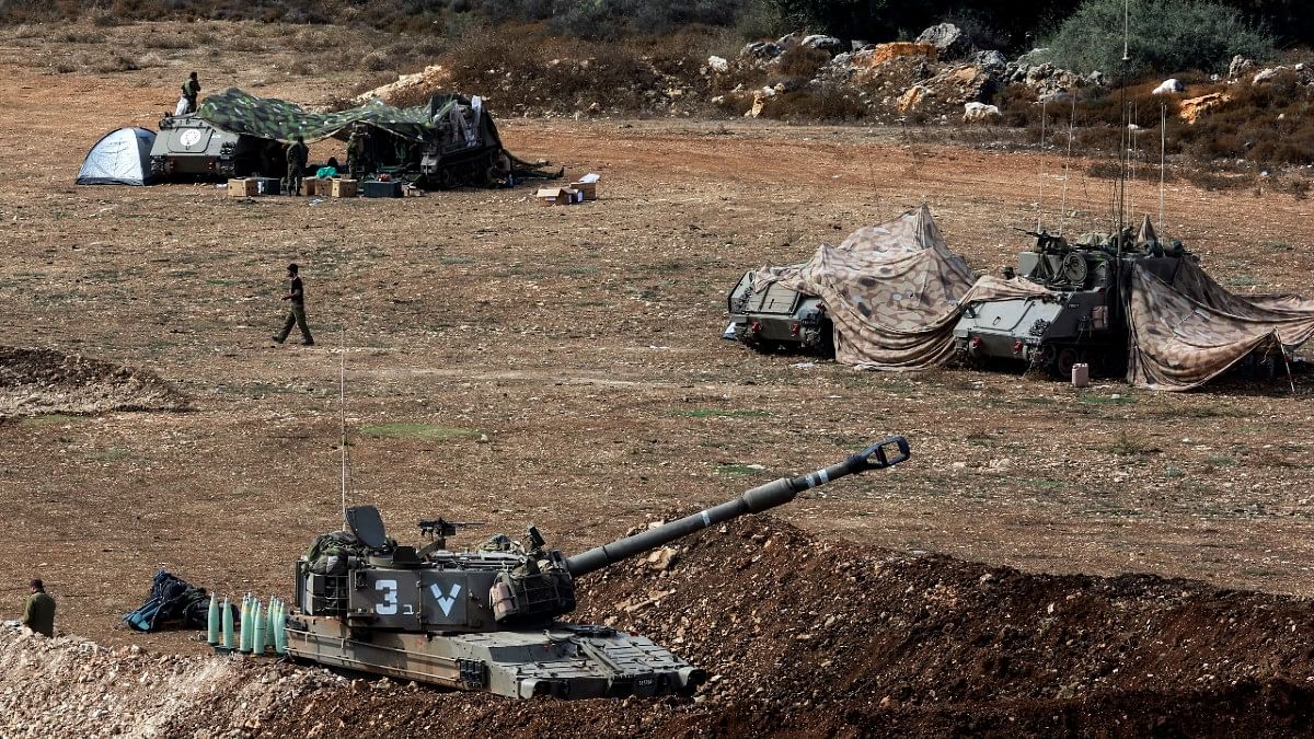 An Israeli tank & military vehicles near Israel's border with Lebanon on 9 Oct 2023 | Reuters/Ammar Awad
