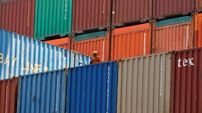 A worker sits on a ship carrying containers at Mundra Port in Gujarat | Reuters file photo