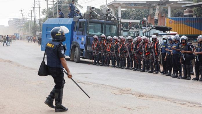 Security forces remain vigilant in front of the garment factories, following clashes between garment industry workers and police over pay, at the Ashulia area, outskirts of Dhaka, Bangladesh, on Wednesday | REUTERS/Mohammad Ponir Hossain