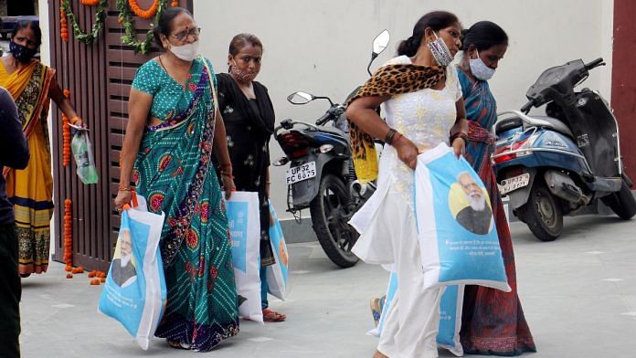 Beneficiaries of PM Garib Kalyan Anna Yojana carry free ration kit distributed in Lucknow | ANI file photo