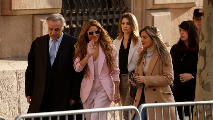 Colombian singer Shakira waves as she arrives with her lawyer Pau Molins at court for her trial facing allegations of tax fraud in Barcelona, Spain, on 20 Nov 2023 | Reuters