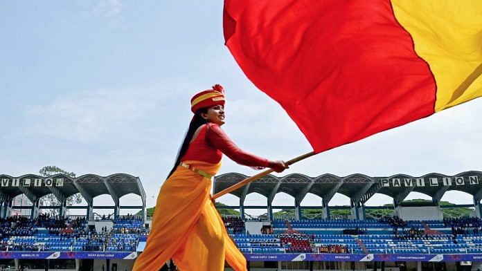 A student waves the Karnataka flag during Karnataka Rajyotsava | ANI