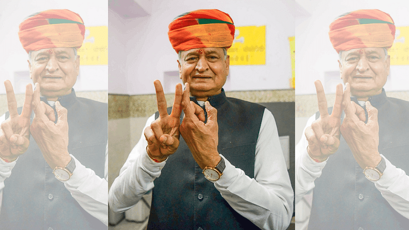 Rajasthan CM Ashok Gehlot shows a victory sign and an ink-marked finger after casting his vote for Rajasthan assembly elections, in Sardarpura, Saturday | ANI