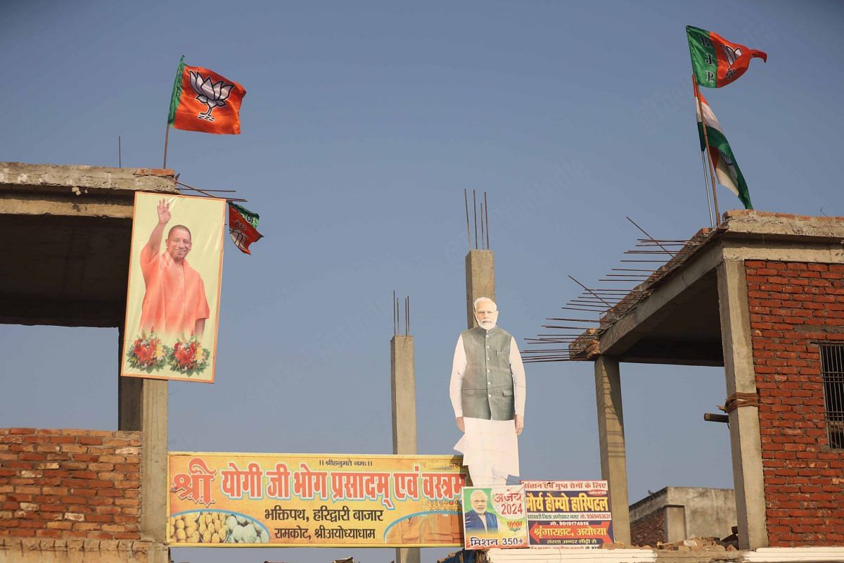 Posters of PM Modi and CM Yogi Aditynath on the road leading to Hanuman Garhi | Photo: Manisha Mondal | ThePrint