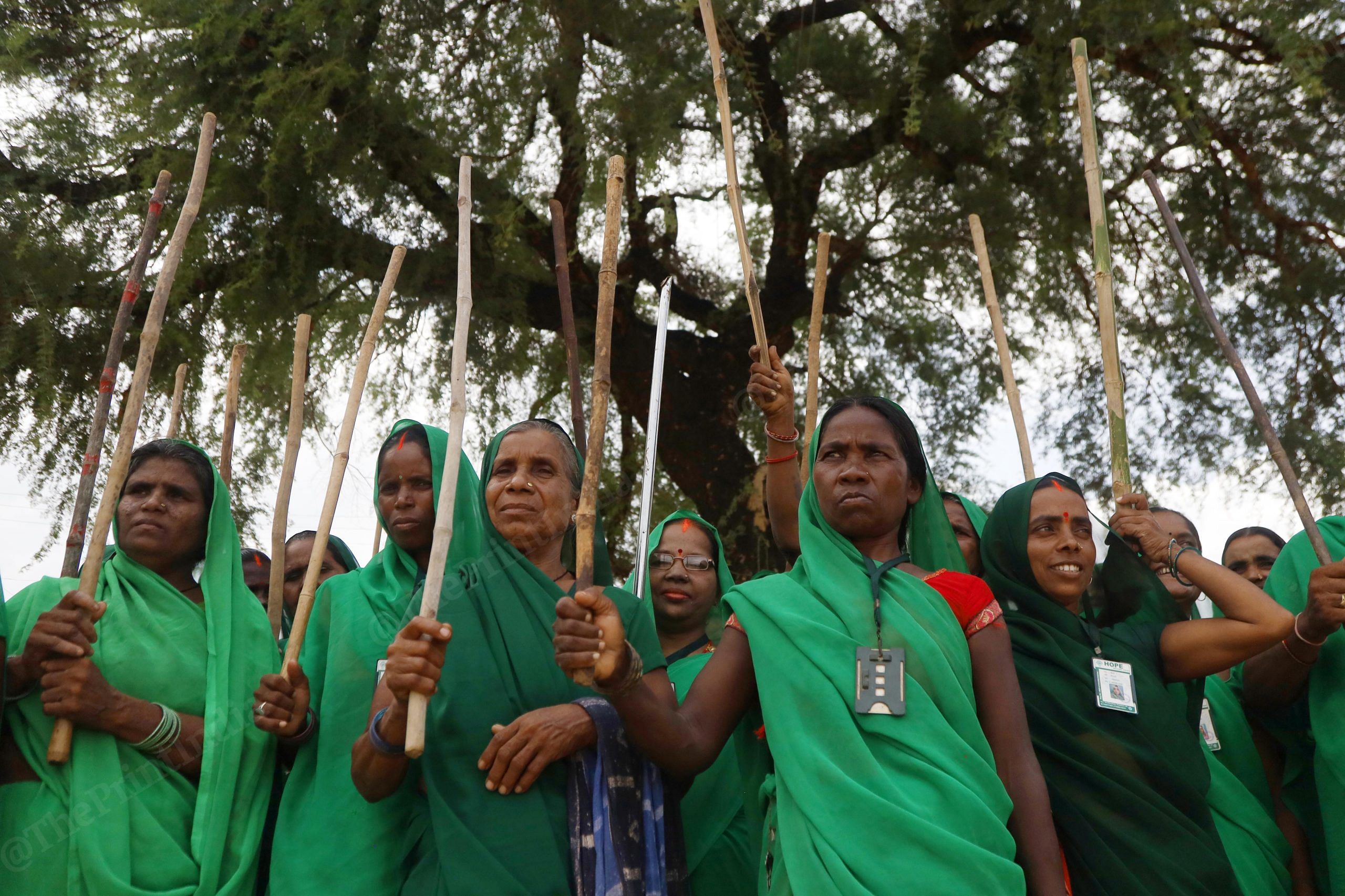The Green Army in Uttar Pradesh was formed for women to take a stand against oppression and violence. This image of a group of Green Army members, heads demurely covered, but armed with sticks for self-defence, is for me a strong message of women's empowerment penetrating some of the most backward sections of society | Photo: Manisha Mondal | ThePrint