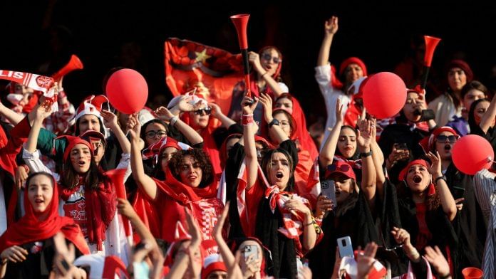 Persepolis soccer team fans cheer at a Persepolis v Sanat Naft-e Abadan match in Iran's Premier League at Azadi stadium in Tehran, Iran August 31, 2022. Majid Asgaripour/WANA (West Asia News Agency) via REUTERS/File Photo