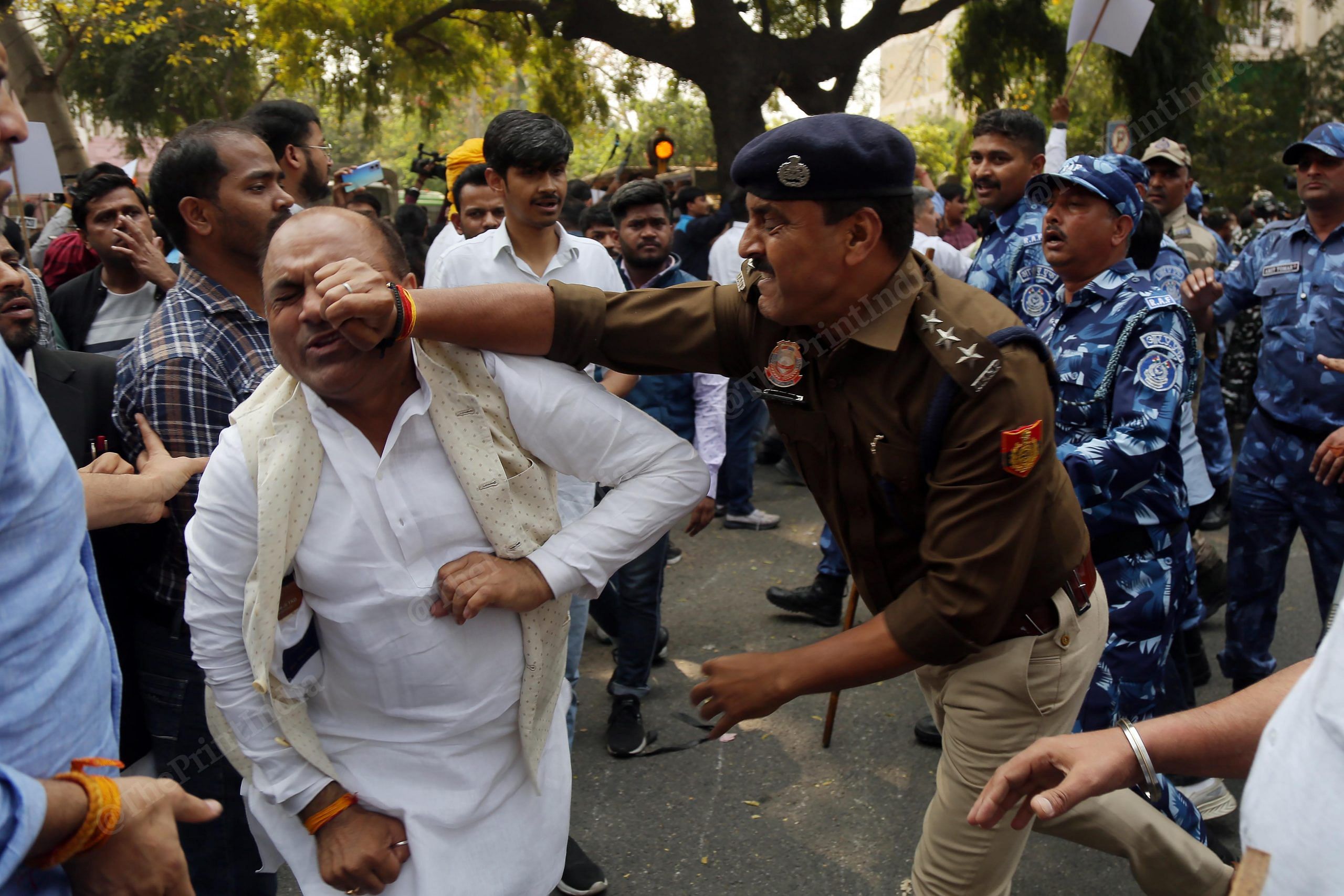 The moment when a Delhi Police officer lost his cool. Captured during an Aam Aadmi Party protest in Delhi this year over the arrest of party leader and former Delhi Deputy Chief Minister Manish Sisodia, this photo of a cop punching a protestor symbolises for me how the police and the public often end up at odds with each other | Photo: Suraj Singh Bisht | ThePrint