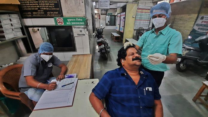 Health official performs Covid test on a man in Thane | PTI