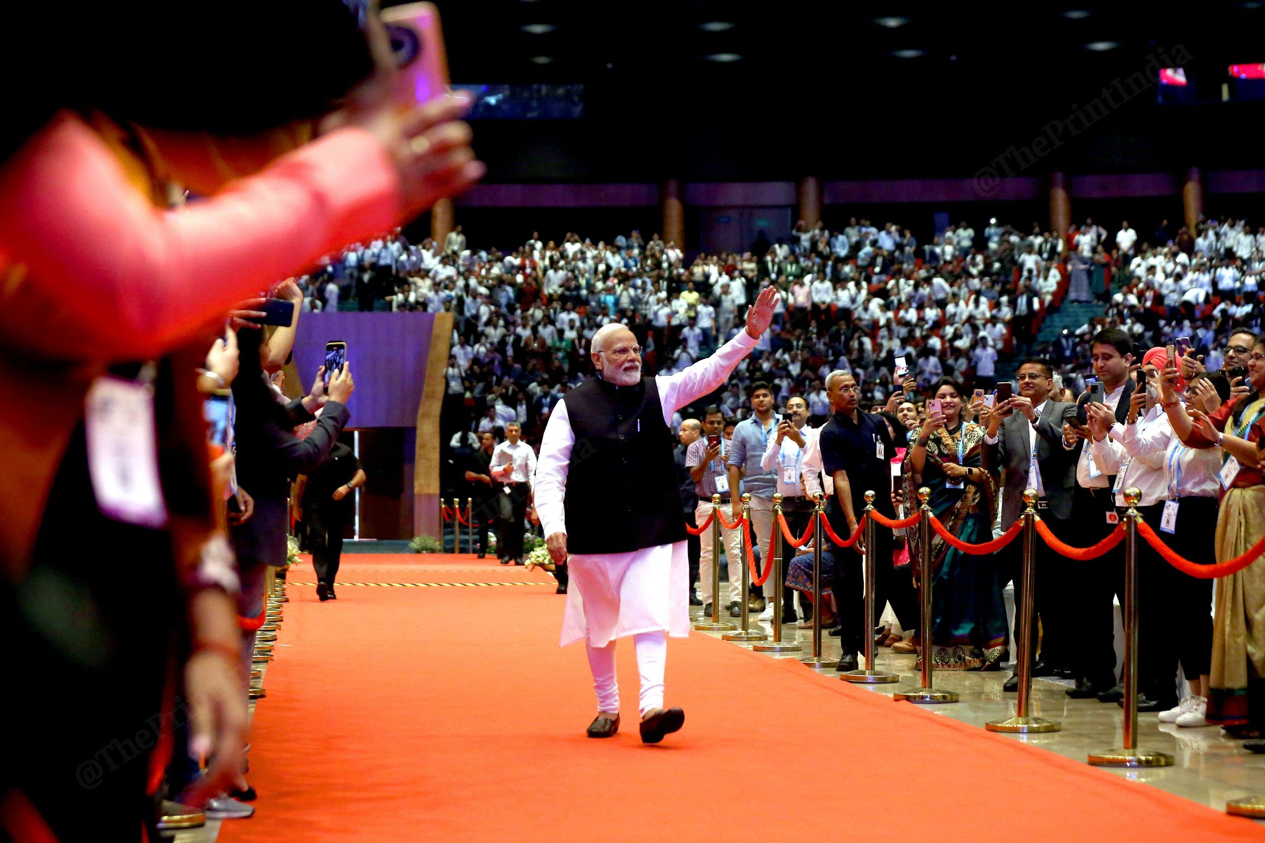 Prime Minister Narendra Modi inaugurates the 7th India Mobile Congress at Bharat Mandapam, Pragati Maidan in October. The striking thing for me here is that the PM can seen walking the red carpet, waving to the crowd, without the security cordon that usually surrounds him | Photo: Suraj Singh Bisht | ThePrint