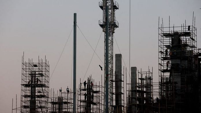 Labourers work at the construction site of a commercial building in New Delhi | Reuters