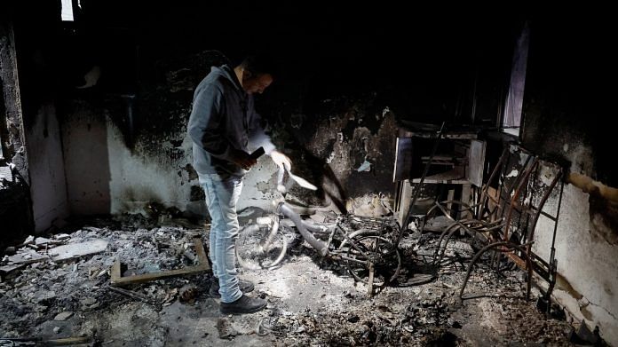 A Palestinian man inspects a damaged bike following an Israeli raid, amid the ongoing conflict between Israel and the Palestinian Islamist group Hamas, in Jenin camp, in the Israeli-occupied West Bank | Reuters
