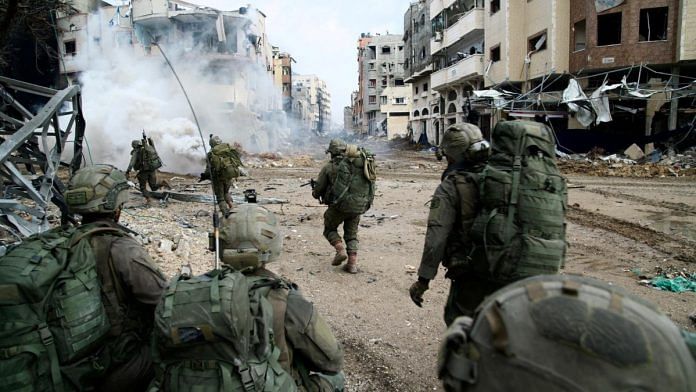 Israeli soldiers operate in the Gaza Strip amid the ongoing conflict between Israel and the Palestinian Islamist group Hamas | Handout via Reuters