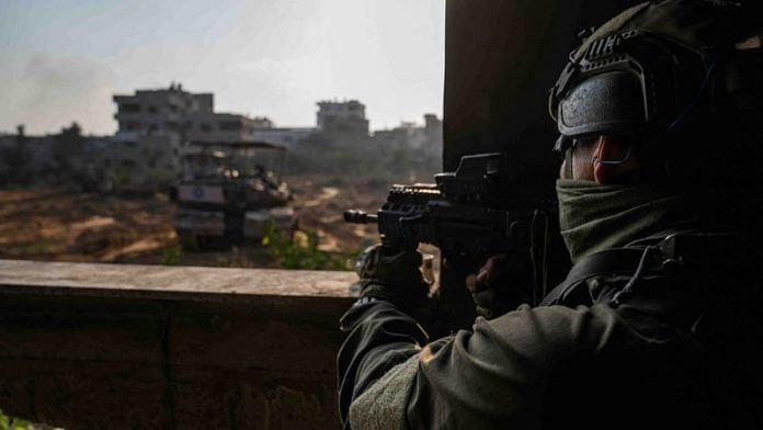 An Israeli soldier operates in the Gaza Strip amid the ongoing conflict between Israel and the Palestinian Islamist group Hamas, in this handout picture released on December 29, 2023. Israel Defense Forces/Handout via REUTERS
