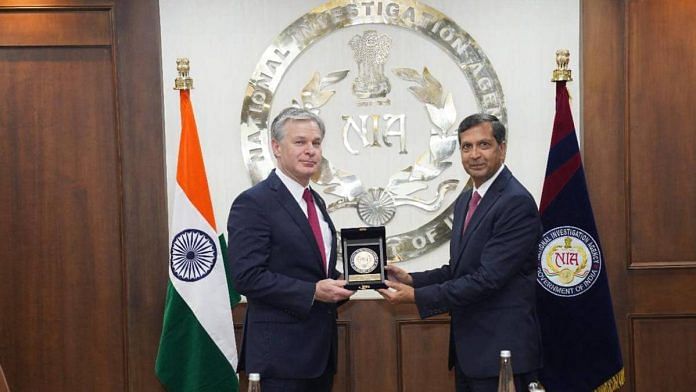 NIA chief Dinkar Gupta (right) presents a memento to FBI head Christopher A Wray | Photo: NIA