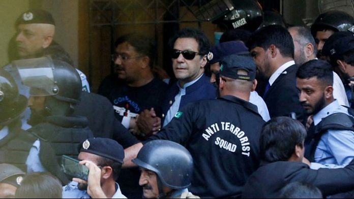 Security officers escort Pakistan's former Prime Minister Imran Khan, as he appeared in Islamabad High Court | Reuters file photo
